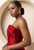 Side profile of crimson floral jacquard corset highlighting structured fit.

