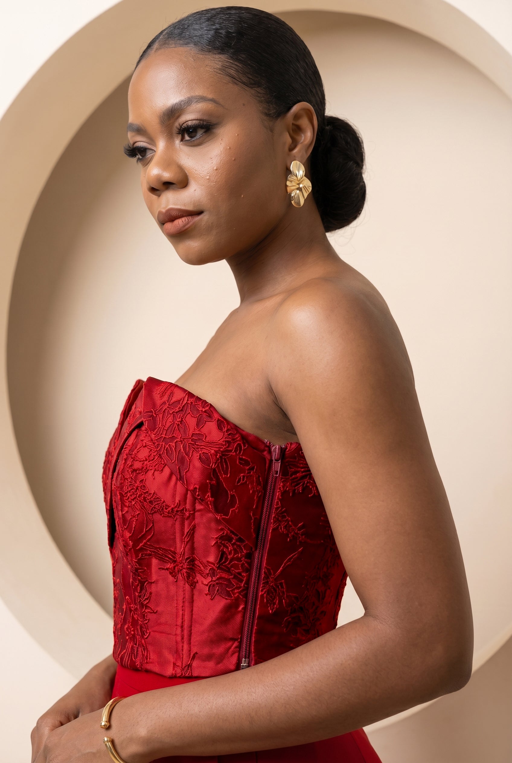 Side profile of crimson floral jacquard corset highlighting structured fit.
