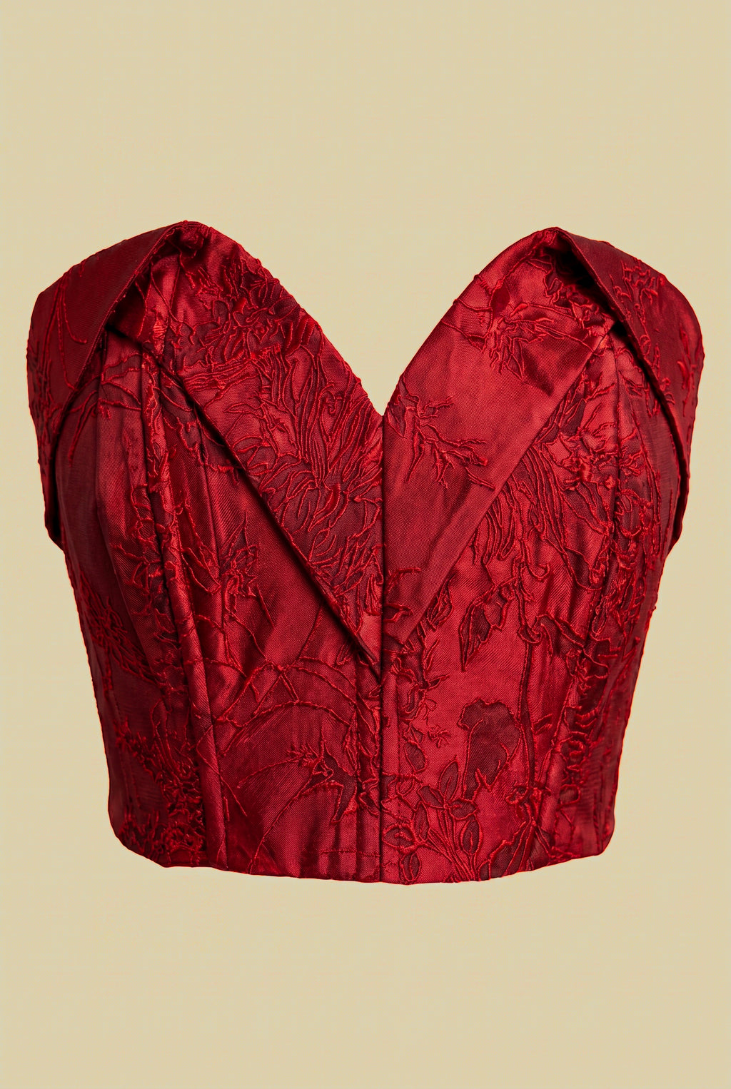 Front view of crimson floral jacquard corset featuring structured bodice and textured floral fabric.